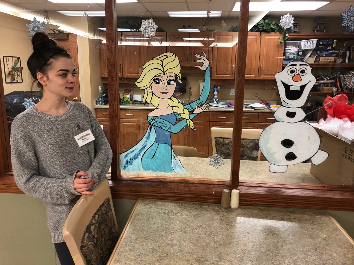 Maia decorated village windows as part of her co-op placement at The Village of Aspen Lake
