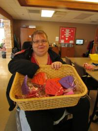Resident Renee holding a basket of crafts