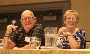A resident and team member sharing a laugh at a conference table