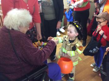 Riverside Glen residents welcomed young people in for a trick-or-treat warm-up before Halloween.