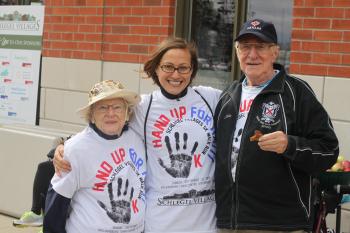 Barbara Skipper, Dagmara Klisz and John Pennington wearing Hand Up for Haiti t-shirts, posing for a photo outside