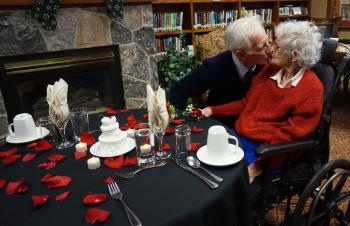 Jim giving his wife Vera a kiss in the Riverside Glen library