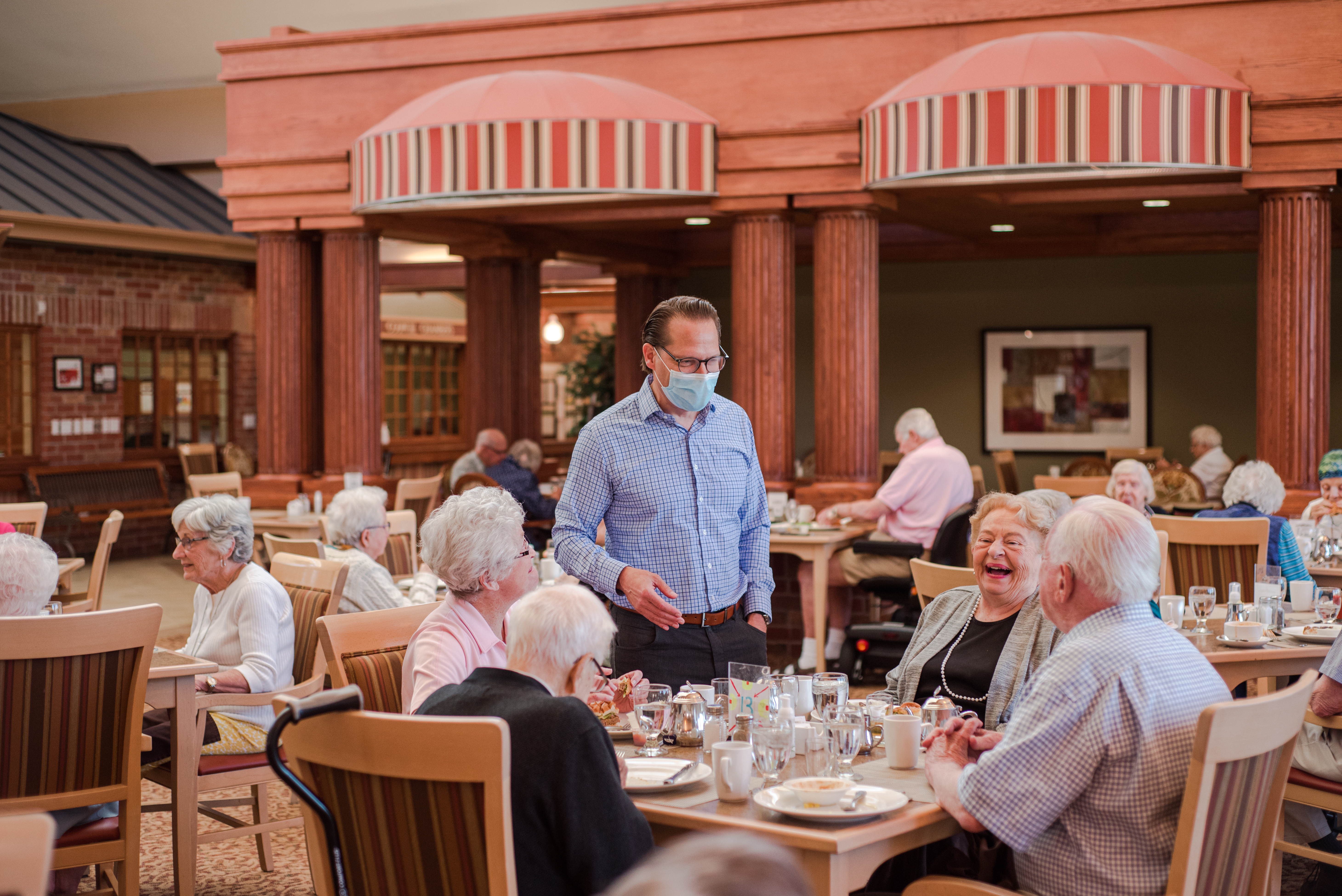 Jamie Schlegel visiting with residents in the Main Dining Room