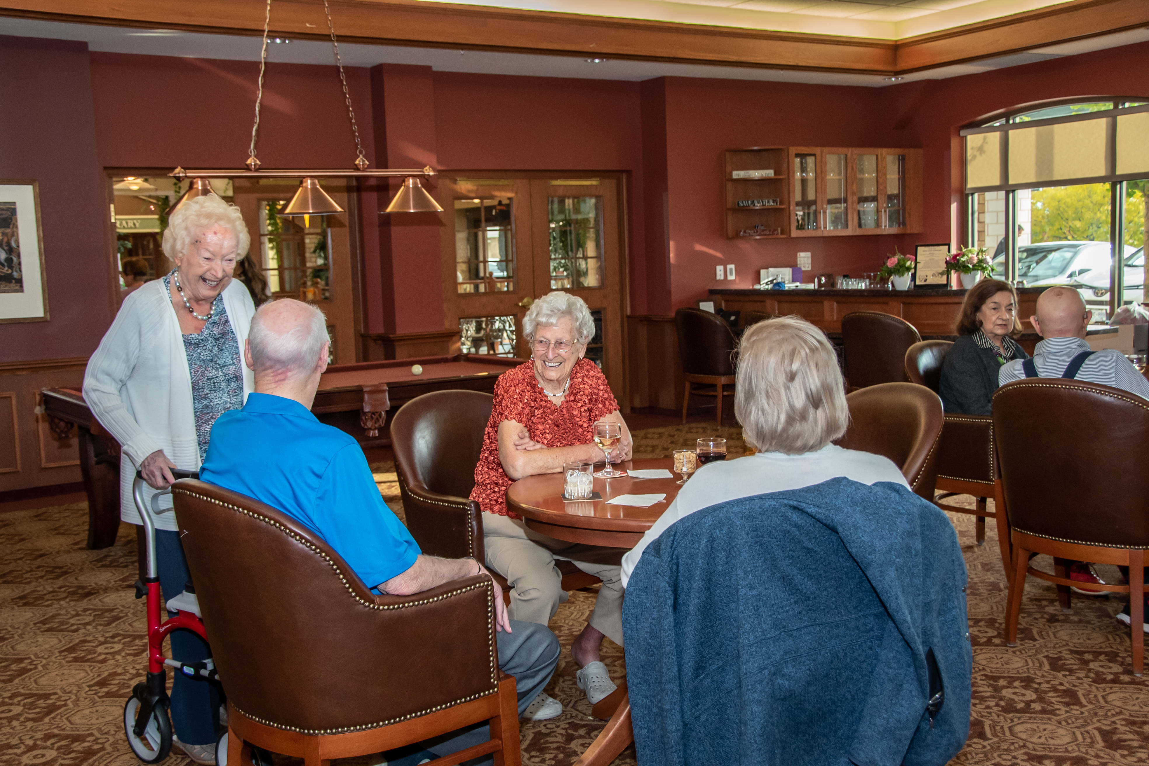 Residents visiting in the Social Club over a drink