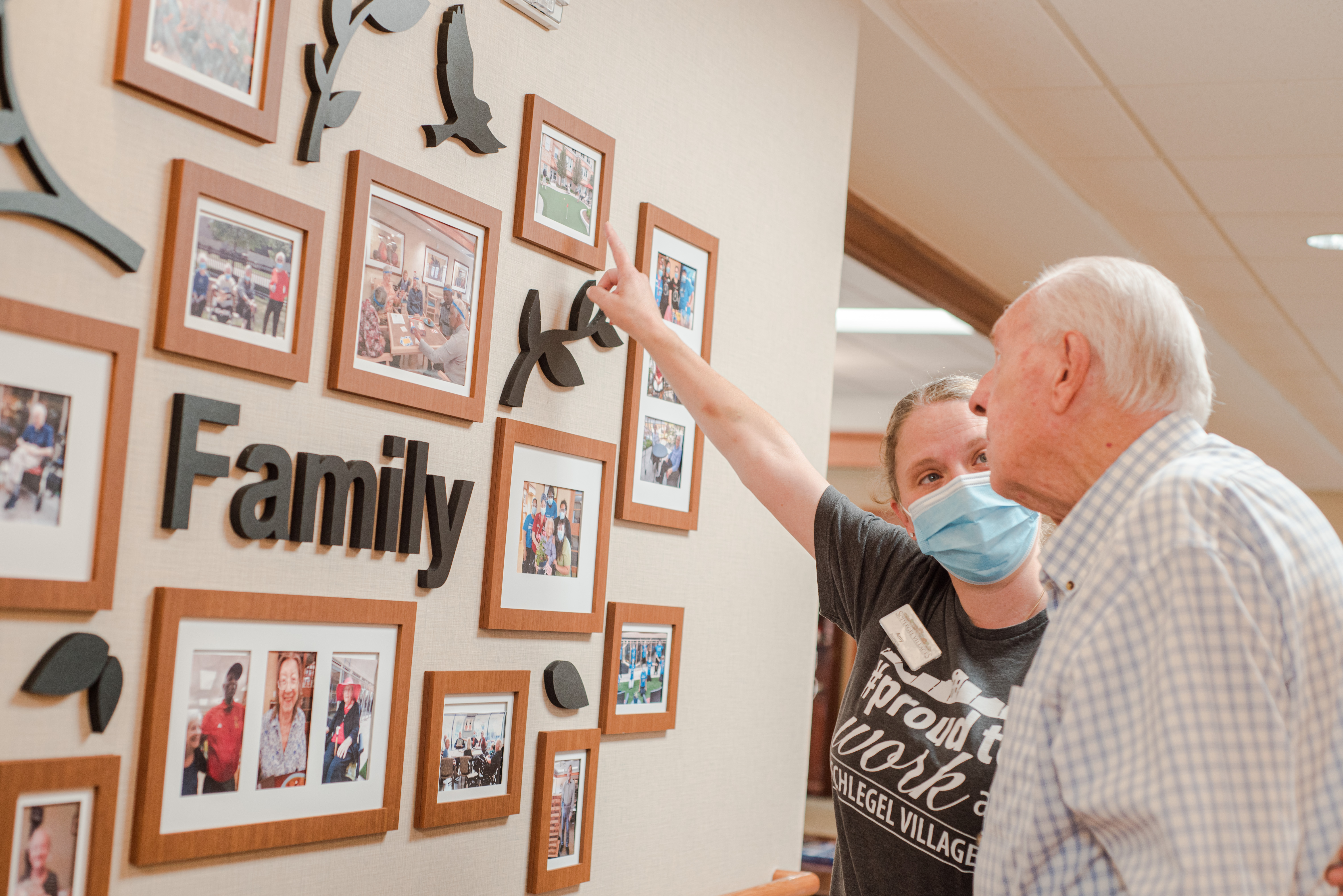 Team member showing a resident a photo in the family photo gallery.