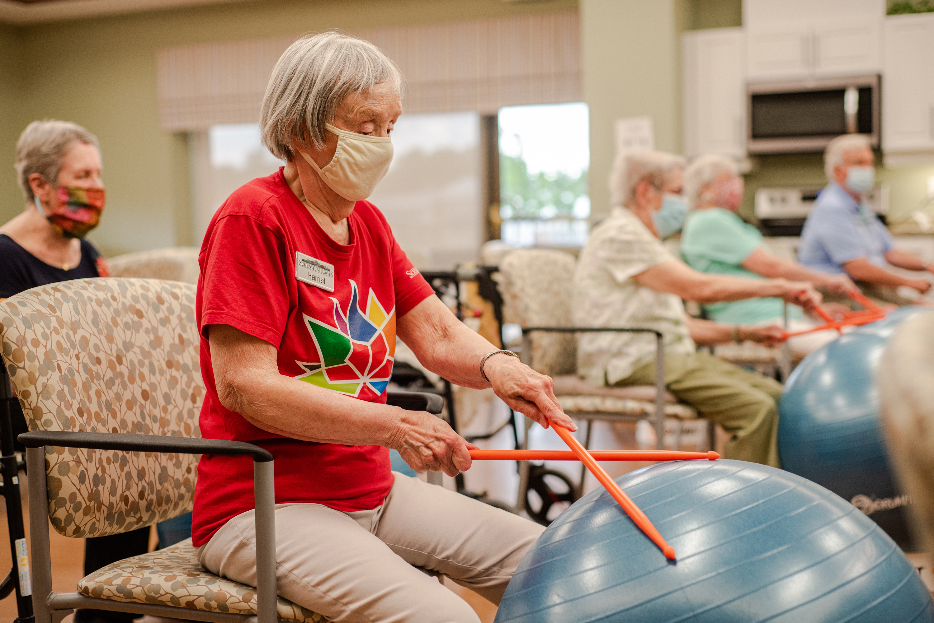 Residents participating in a drum fit class