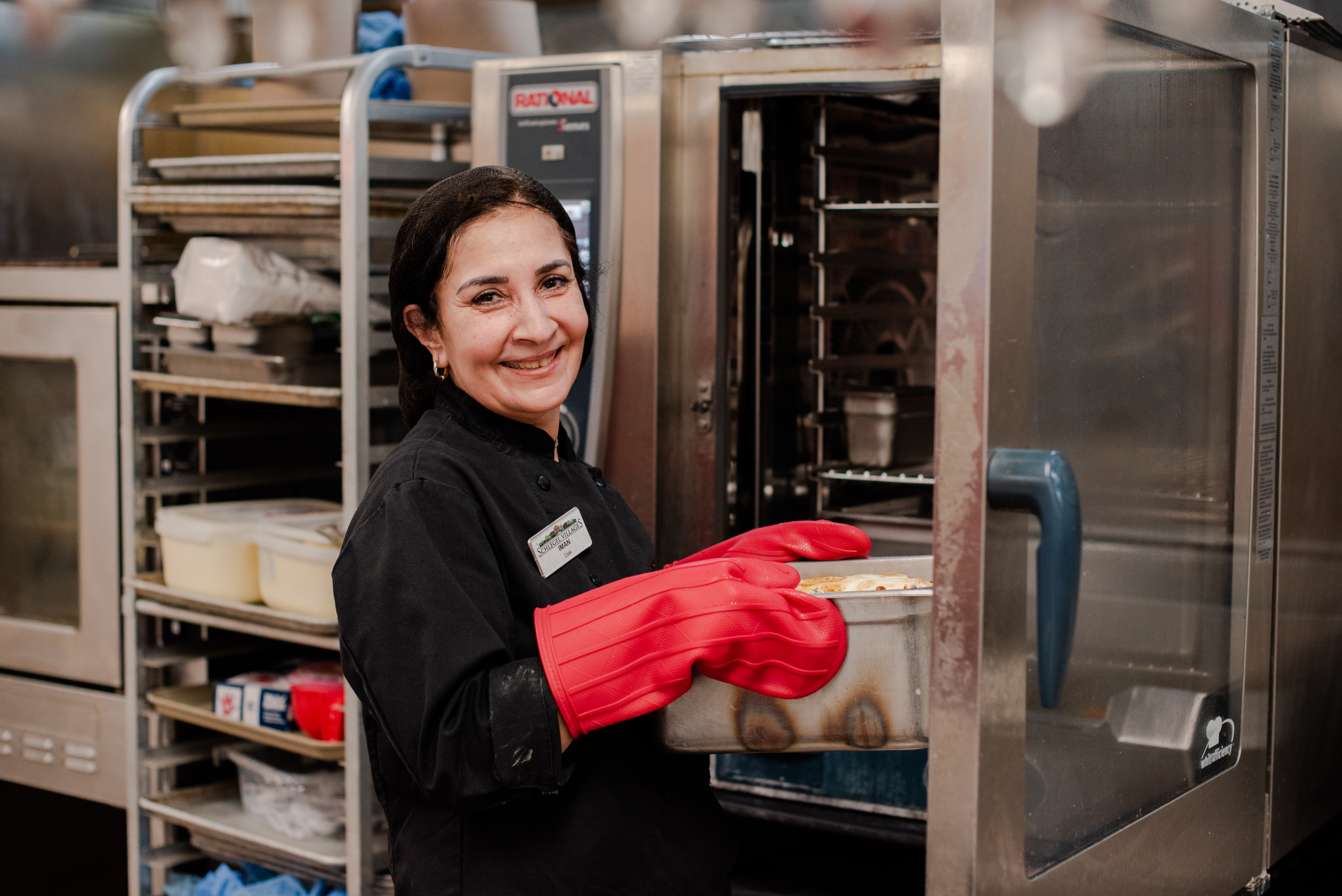 Team member and cook smiling in the Kitchen