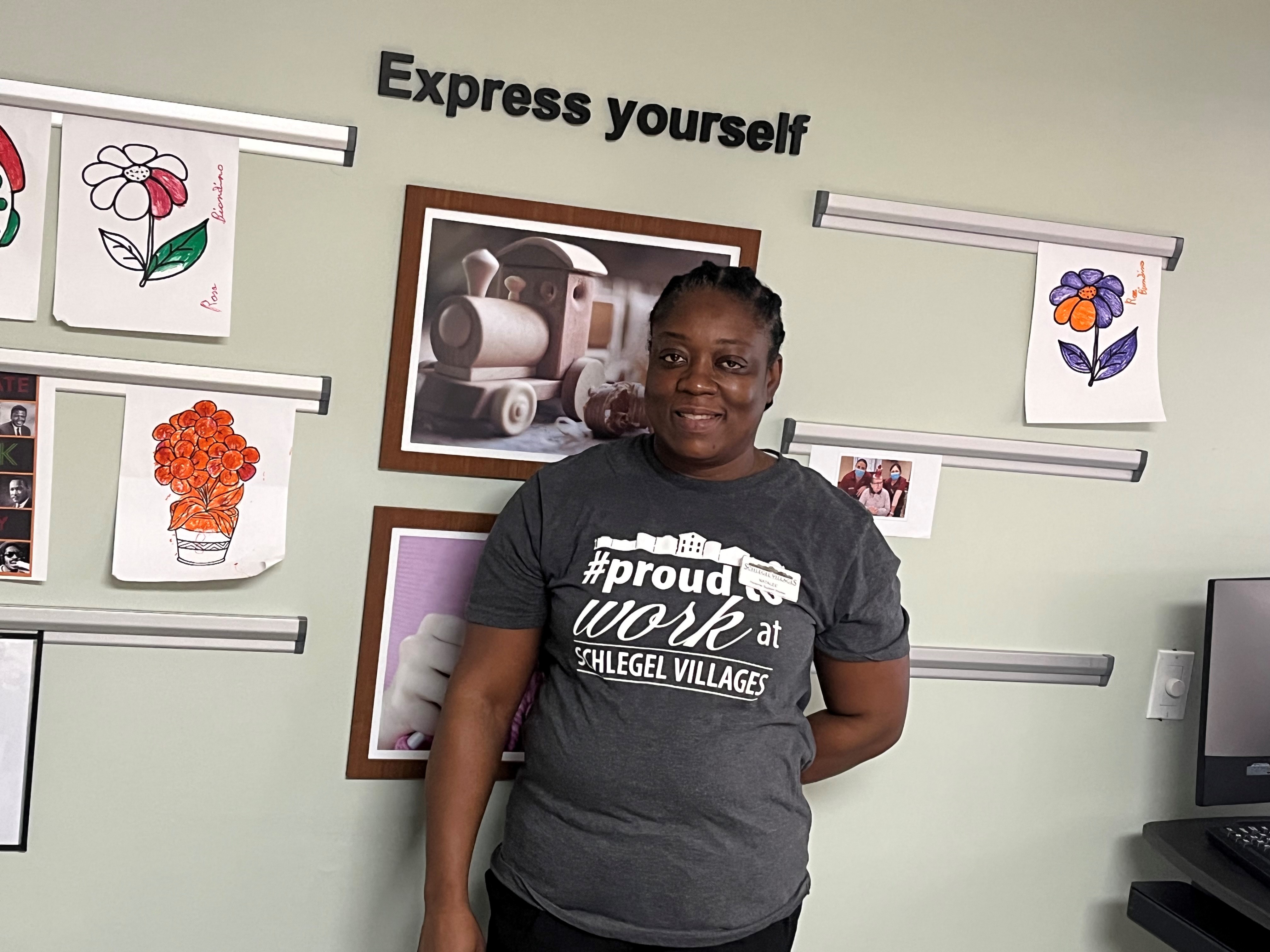 Natalee Chambers poses in her #ProudToWorkAt Schlegel Villages shirt at the Express Yourself art display at Humber Heights