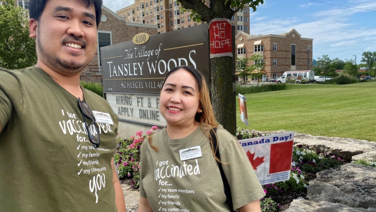 Michael and Michelle pose in front of the Tansley Woods sign and building