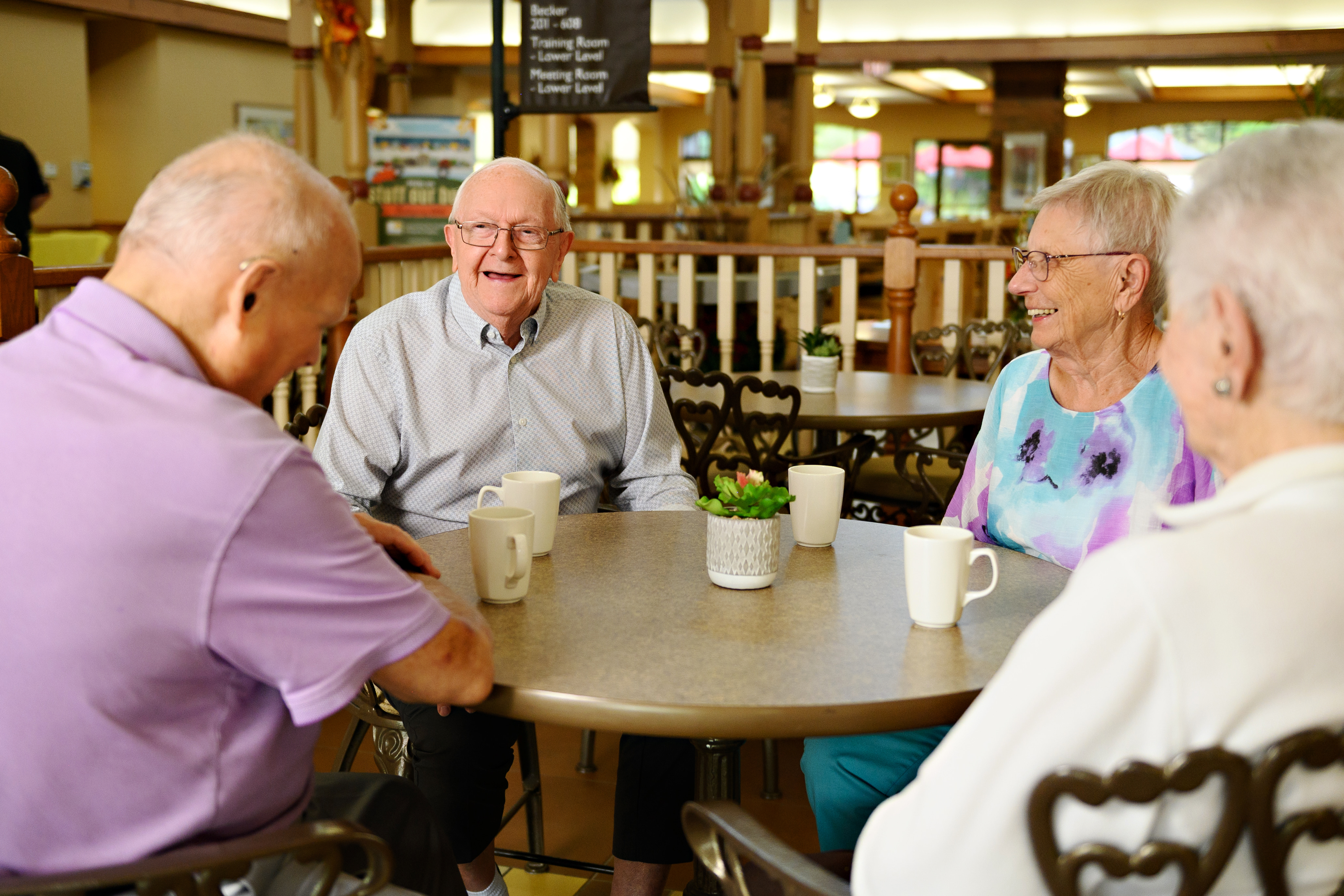Seniors sit with Ron Schlegel in the Village Cafe