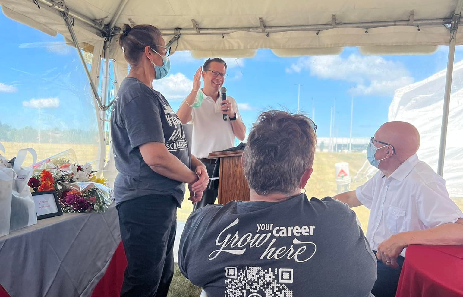 Jamie Schlegel addresses the group during the celebration of The Village of Sandalwood Park 20th anniversary