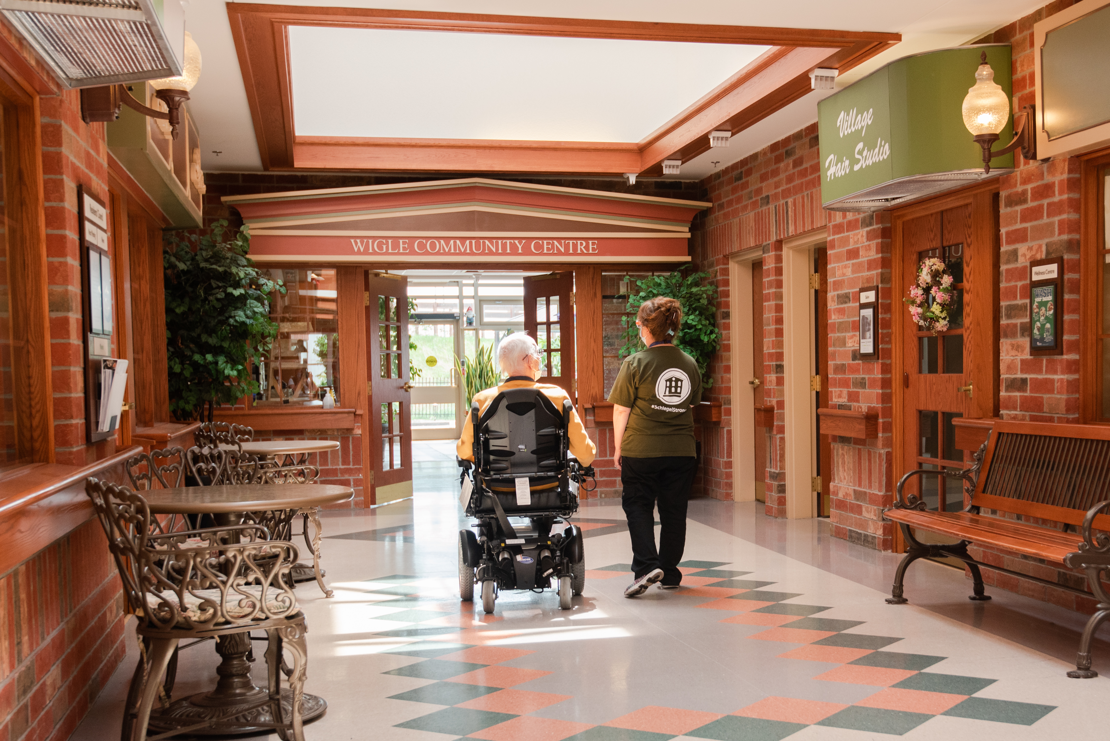 Team member walking with resident on Main Street