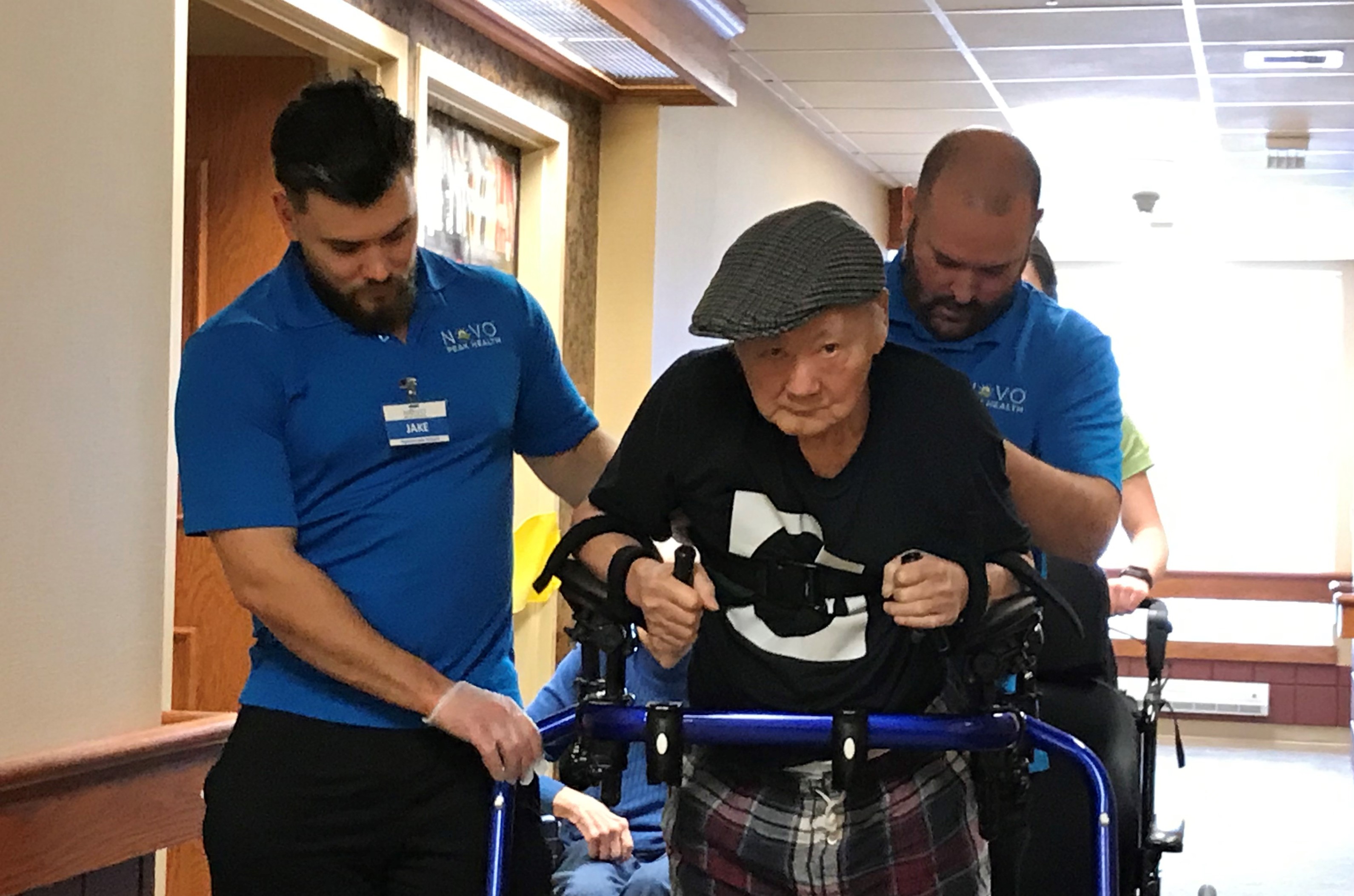 Physiotherapy assistants Jake and Steve work with Mr. Tran during his regular exercise efforts in The Village at St. Clair. 