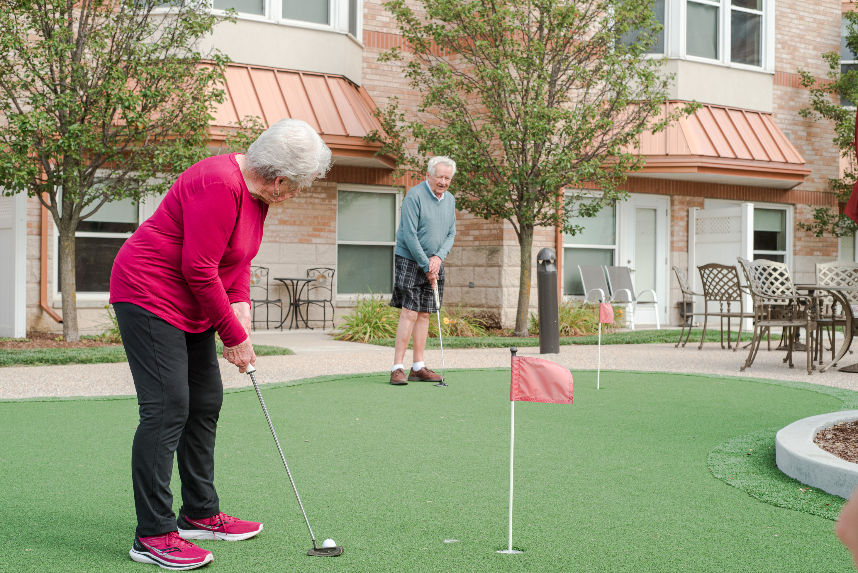 Residents practicing their strokes on the Courtyard putting green
