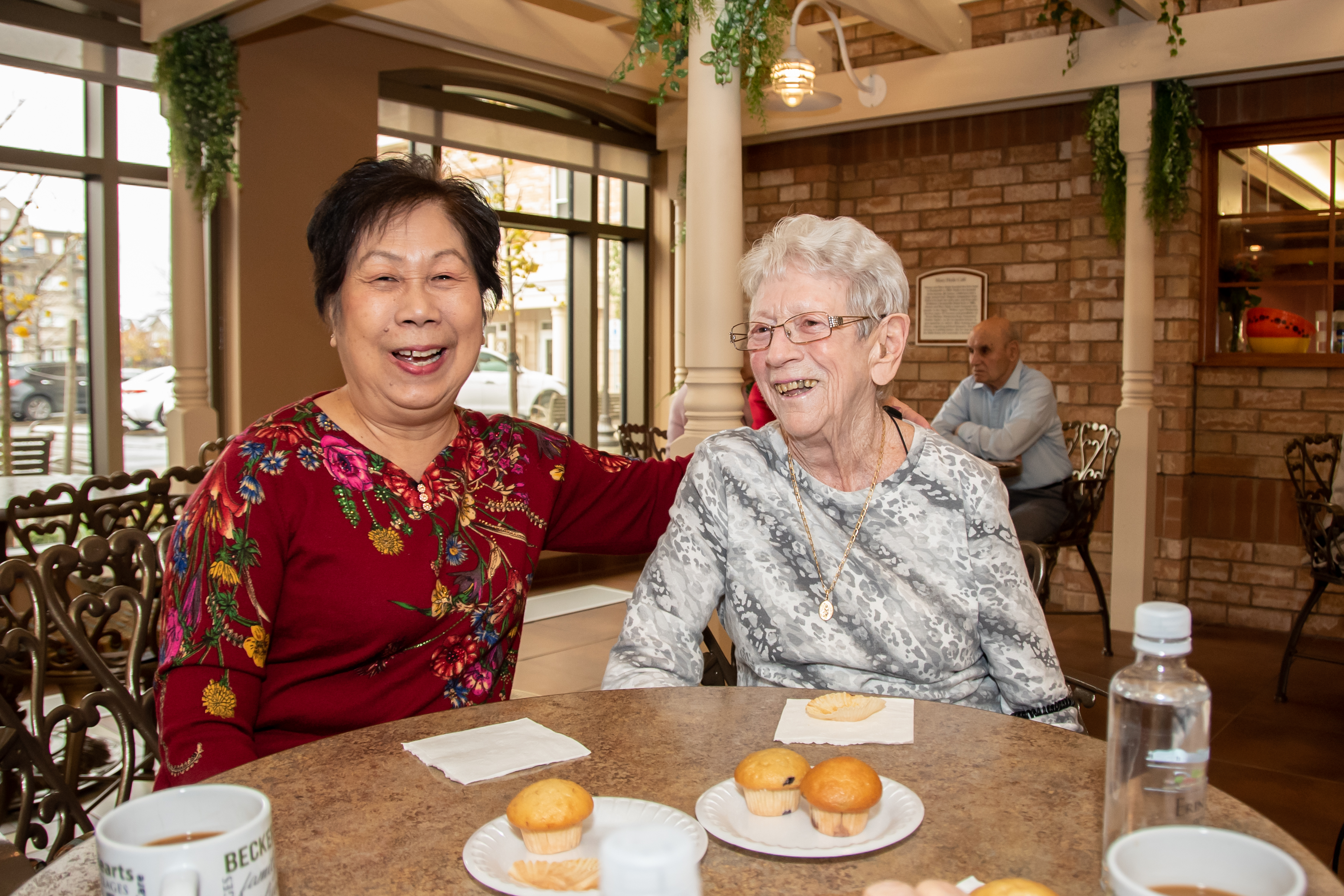 Two residents laughing in the Cafe