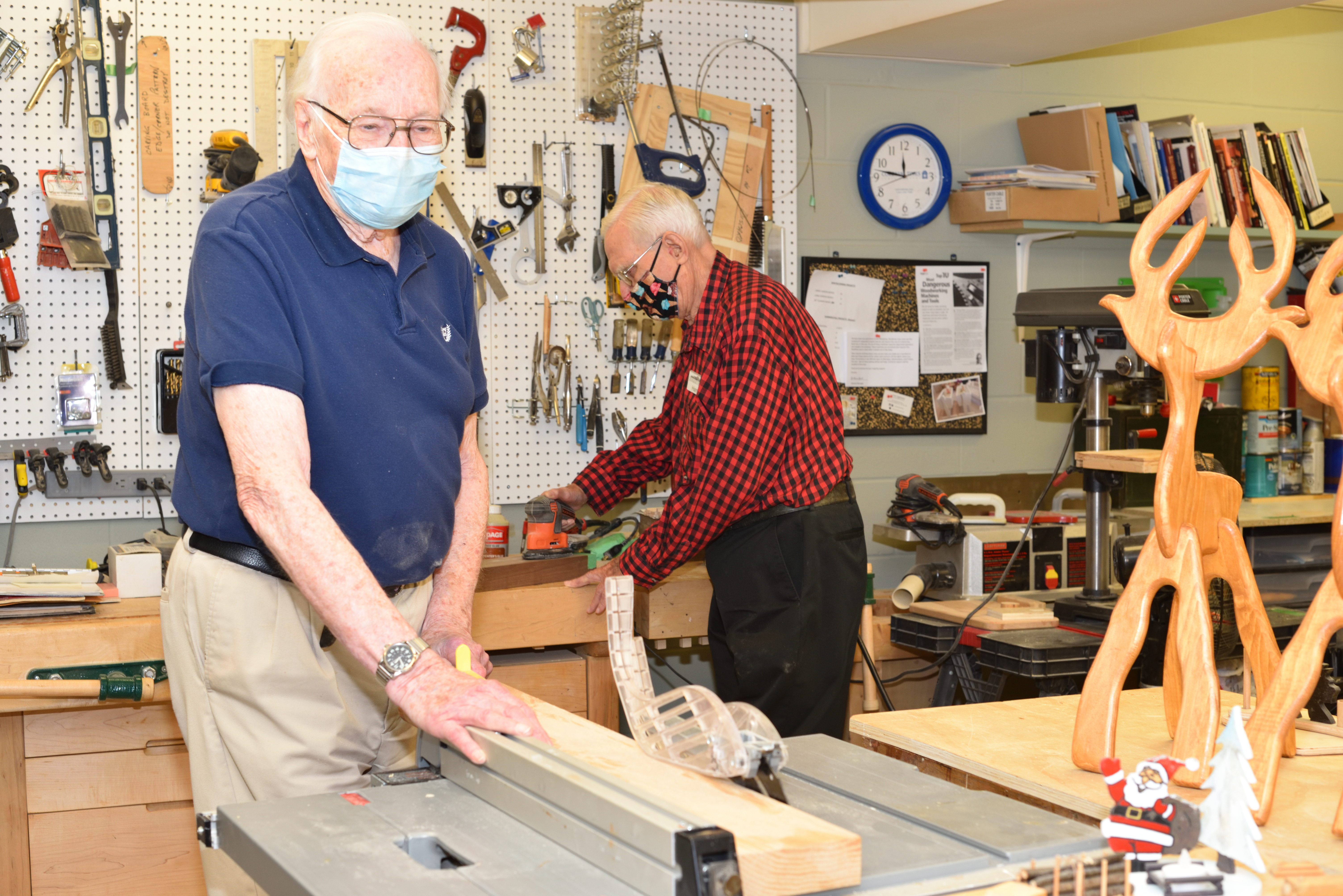 Two residents woodworking in the Wood Shop