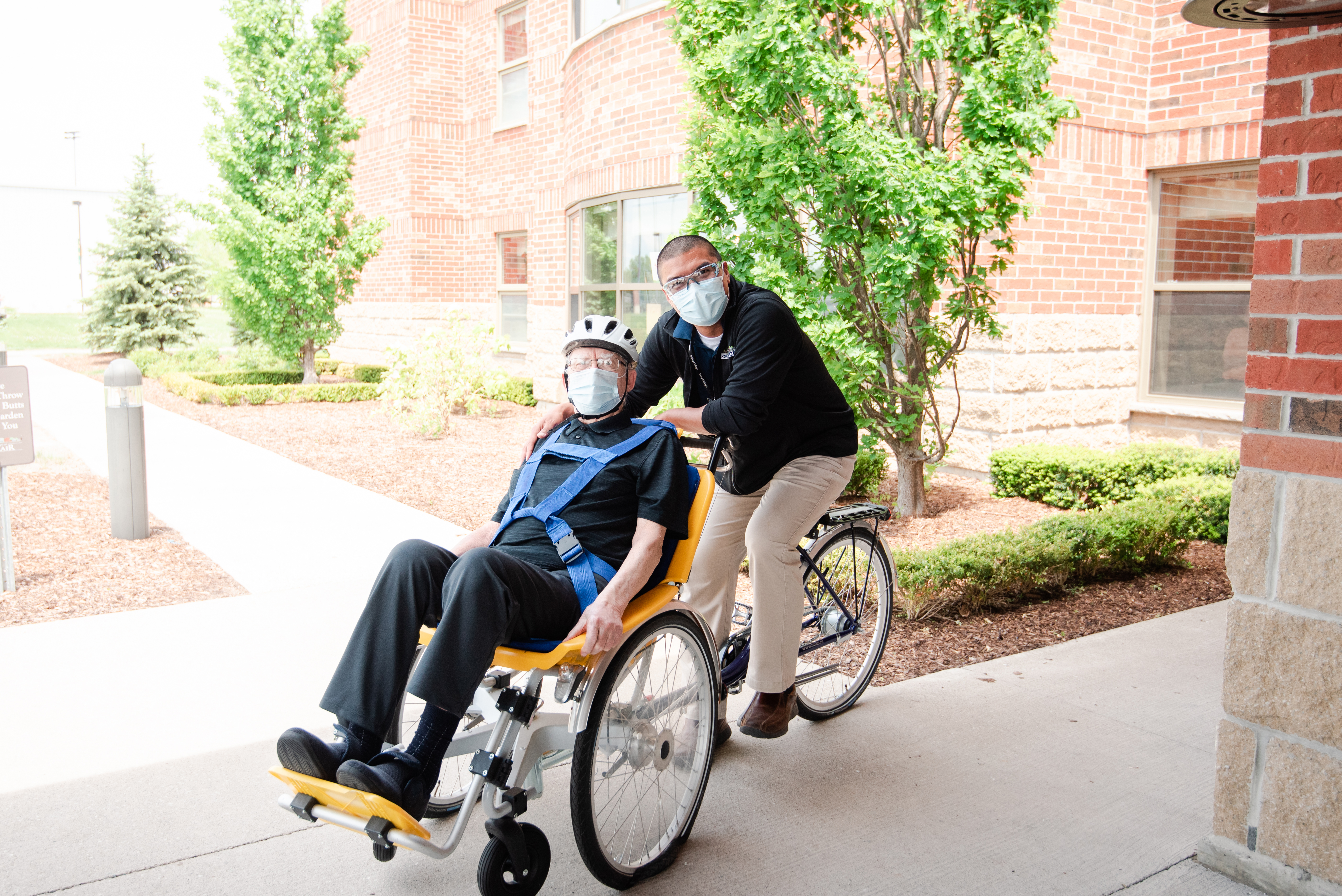 Resident and team member enjoying a ride on an adaptive bike