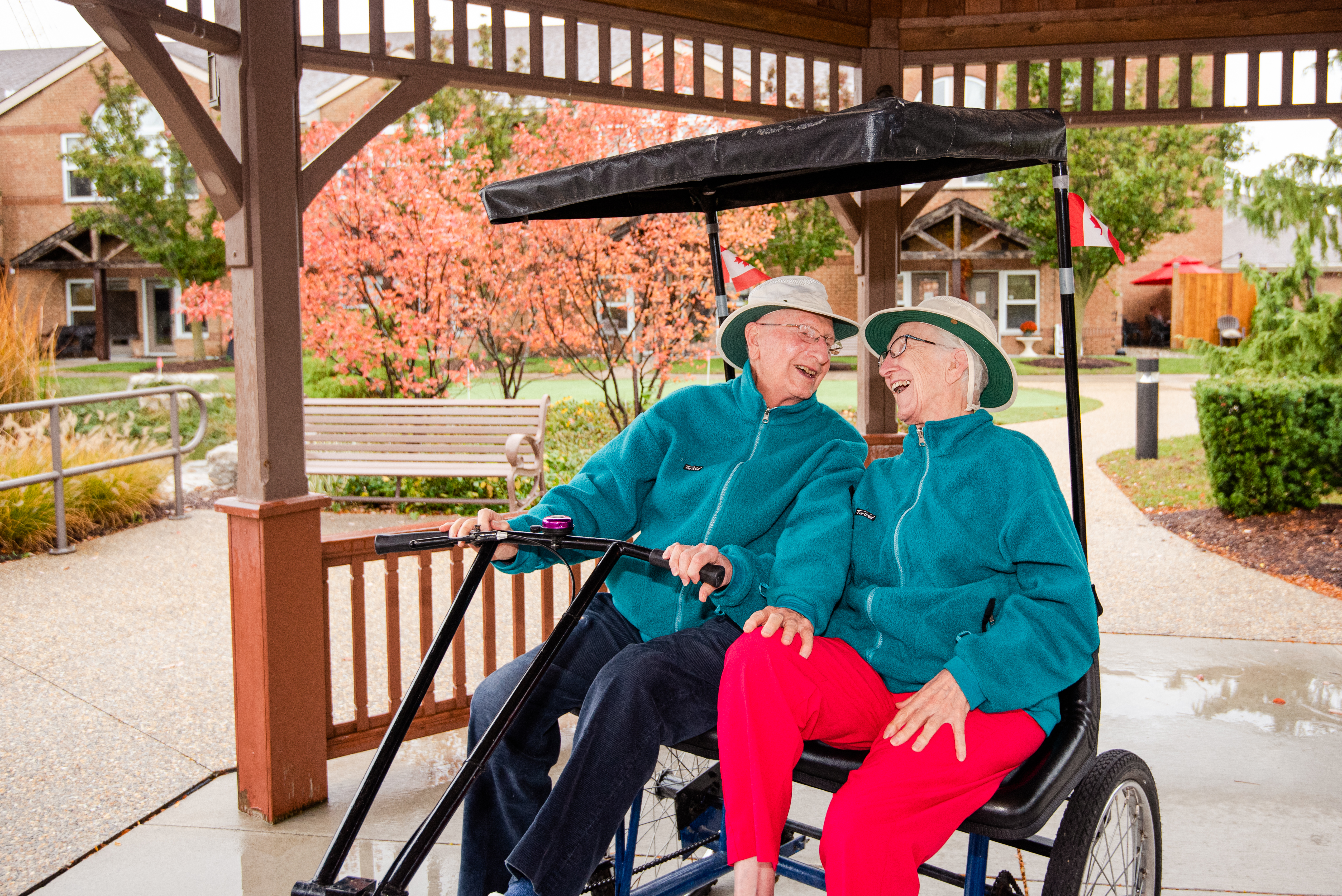 Resident couple enjoying a ride on their dual tricycle in the Courtyard