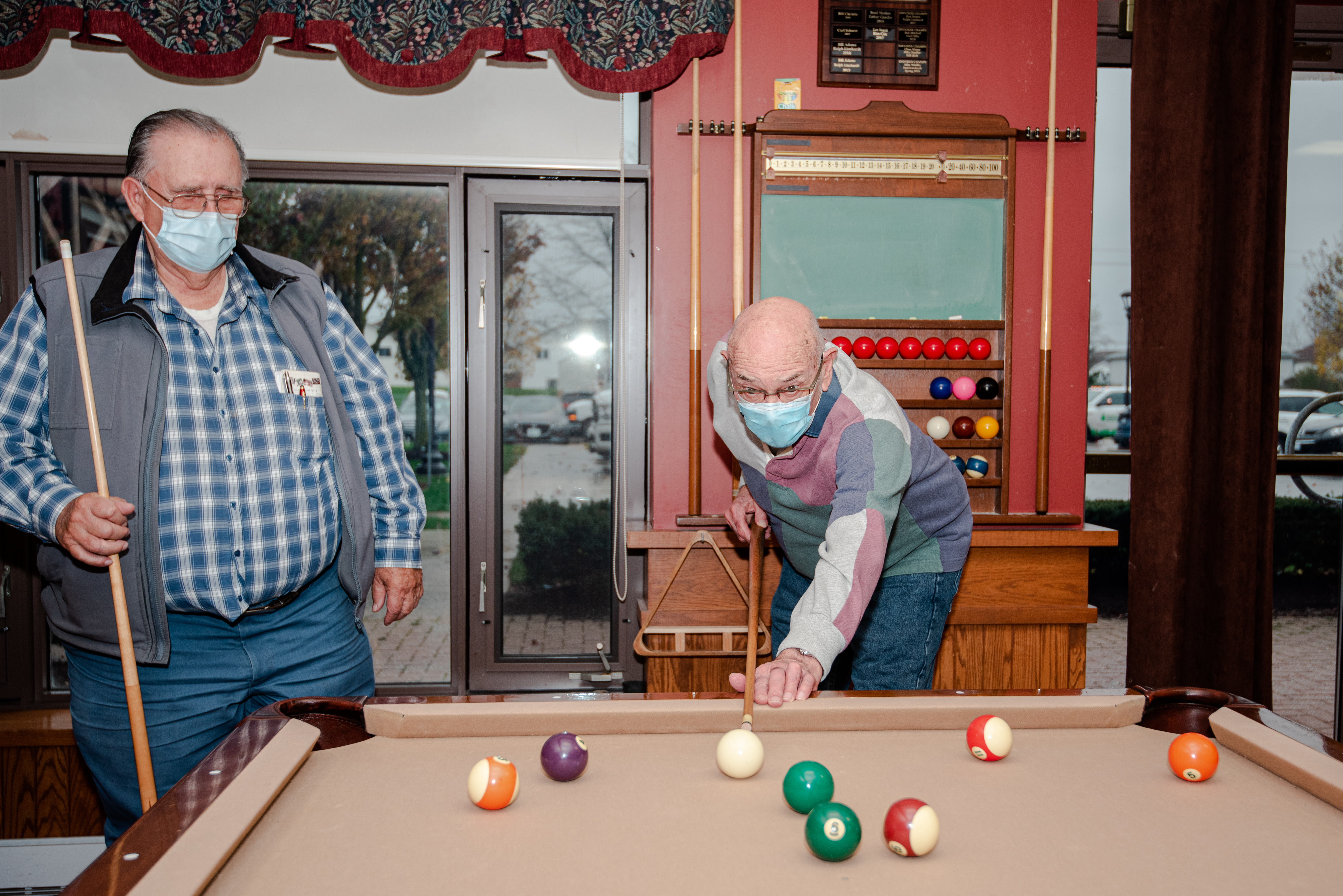 Two residents playing a game of pool in the Social Club