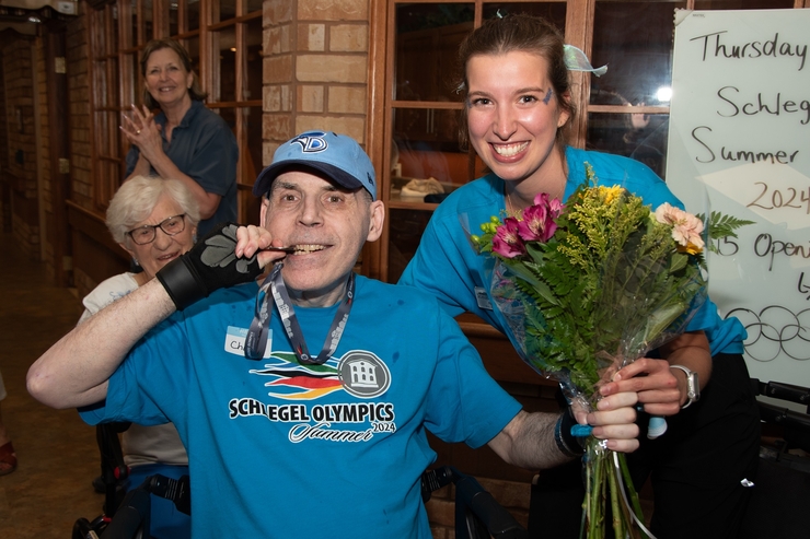 Resident bites into his Schlegel Olympics Medal