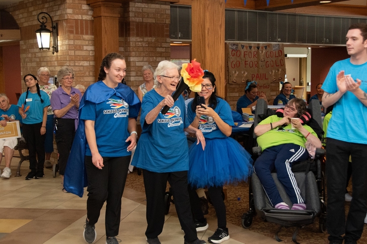 Resident carries the Schlegel Olympics Torch