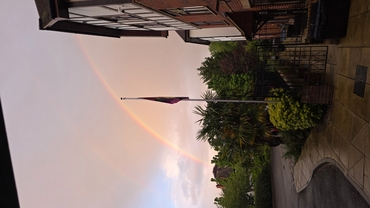 A rainbow paints the sky above the walls of Maycroft Manor.