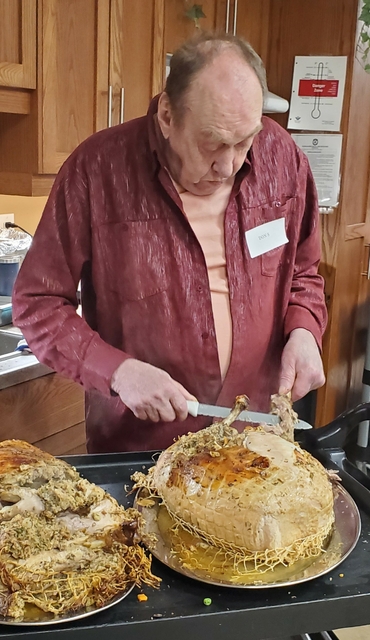 Don Steinman had the honour of carving the turkey for the friends that had gathered for the holiday feast at University Gates.