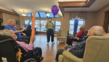 Bharthi is surrounded by residents in a during an exercise program.