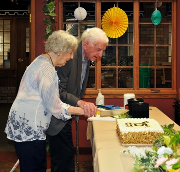 Bill and Helen cut their 75th Anniversary cake together. 