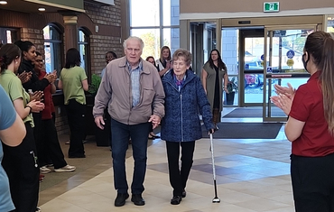 Bruce and Dorothy walk across the threshold on moving day at Glendale Crossing.