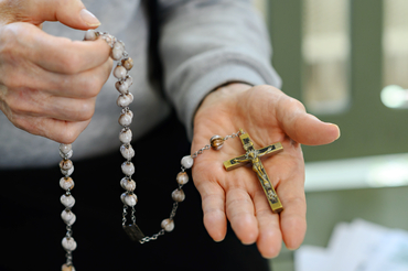 Joao holding a rosary