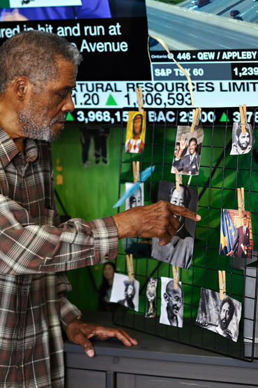 Augusto pointing to pictures of people around the world who inspire him