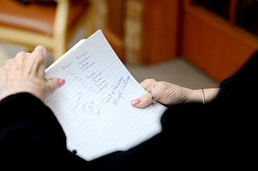 Jane holding a list of where students have come from that stayed with her