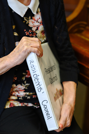 Winifred Robb holding the Residents' Council binder