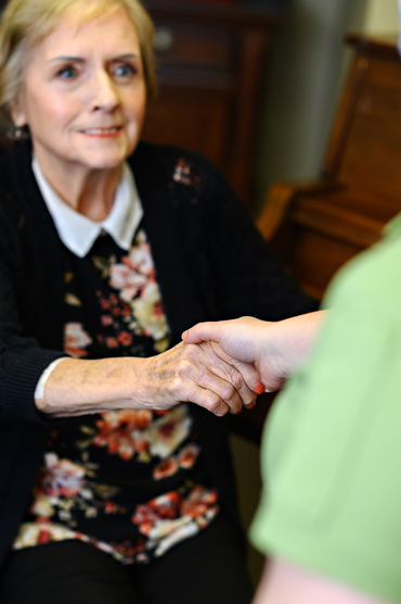 Winifred Robb holding the hand of a team member