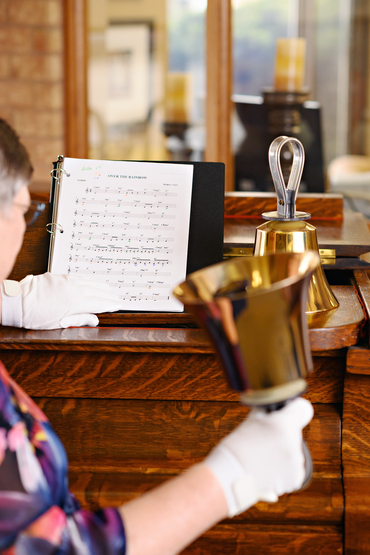 Kathryn Wall reading music and playing handbells