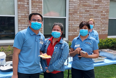 Frank, Jesica and dietary team member, Carolyn Chow pose during a caregiver's week celebration at Riverside Glen.&nbsp;
