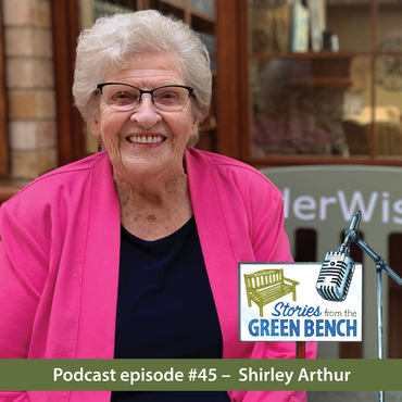 Shirley Arthur sitting on the green bench as part of the elder wisdom podcast