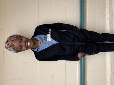 Zee smiles wide in her uniform at Hamilton Continuing Care. 