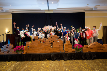 Graduates of the Leadership in Seniors Living Program are celebrated on the stage at the 2023 Schlegel Villages Leadership Retreat.