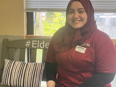 Marwa, who has a remarkable story of her journey to Coleman Care Centre, sits and smiles for the camera.