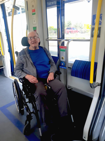 Myron is out and active on a city bus in his wheelchair. 