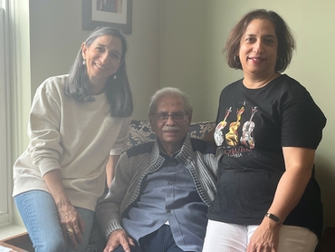 Nari sits with his daughters, Cyra and Shaan, in his suite at Erin Meadows.