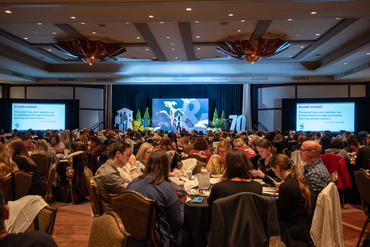 The conference room is filled with attendees as they discuss leadership growth mindset at the Operational Planning retreat.