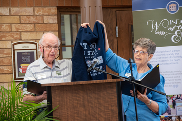 Bob & Emily hold up sweatshirt during speech