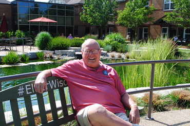 Ron Schlegel sitting on our #ElderWisdom Green Bench