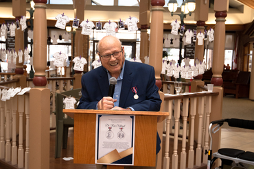 Ron Schlegel speaking at a podium
