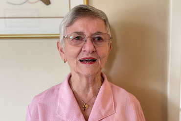 Sue Sprake smiles as she poses for the camera. 