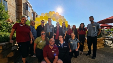 University Gates team members gather during the annual Fall carnival at the Village. 