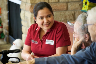 A team member is pictured in conversation with residents.